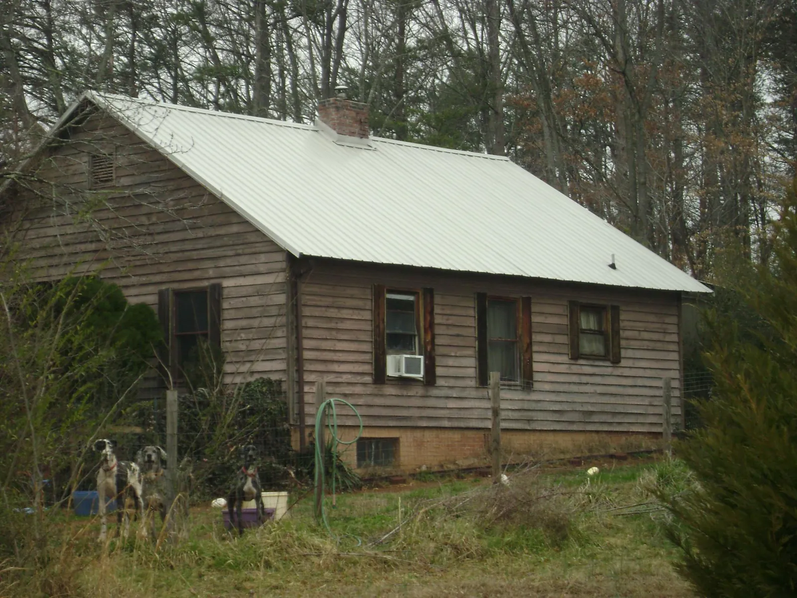 White metal roof on an old wood sided farmhouse, from a Metal Roof Installation job in Rosamond